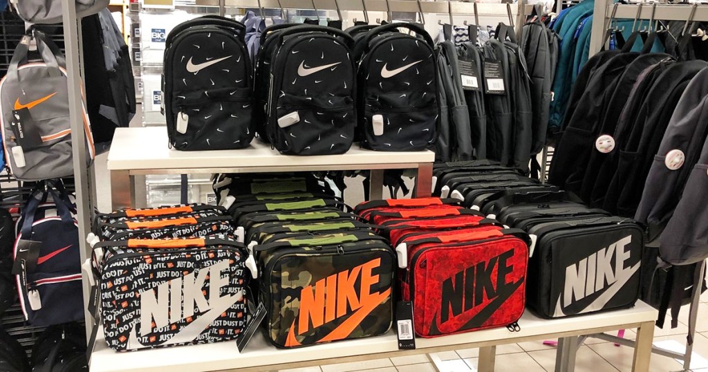 store display table full of various colors and prints of Nike brand lunchboxes