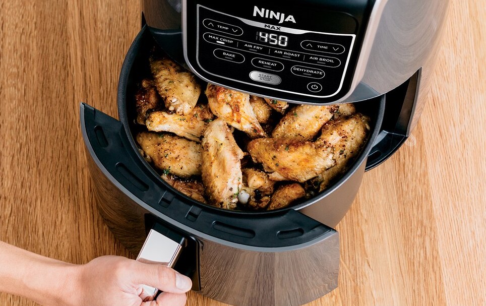 hand opening basket on an air fryer
