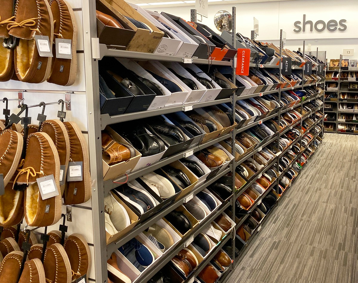 clearance racks full of boxes of men's shoes