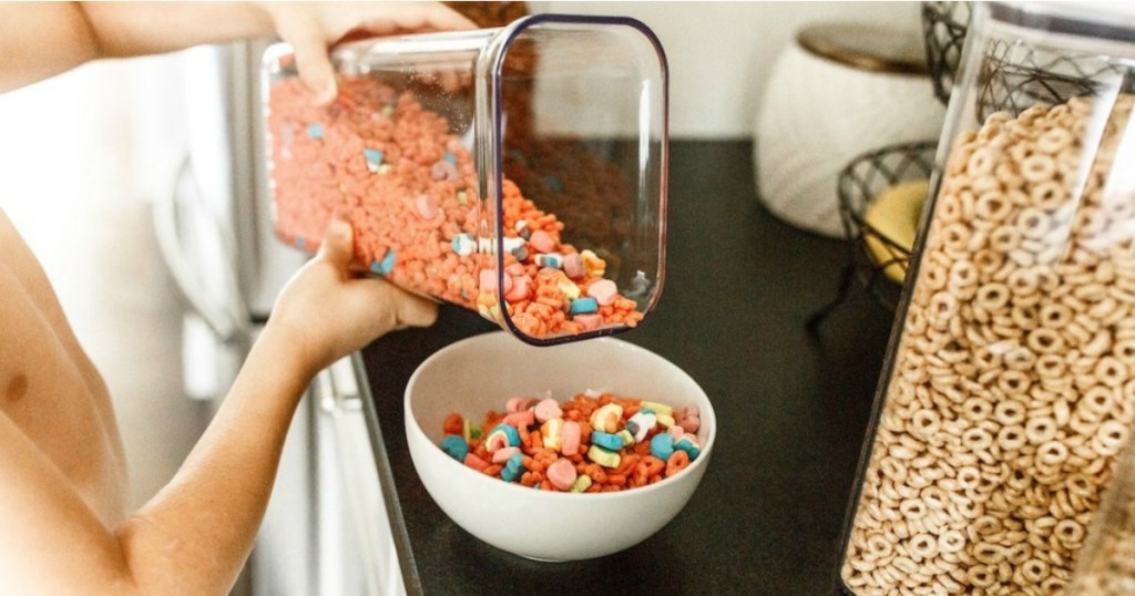 kid pouring cereal from OXO container into bowl