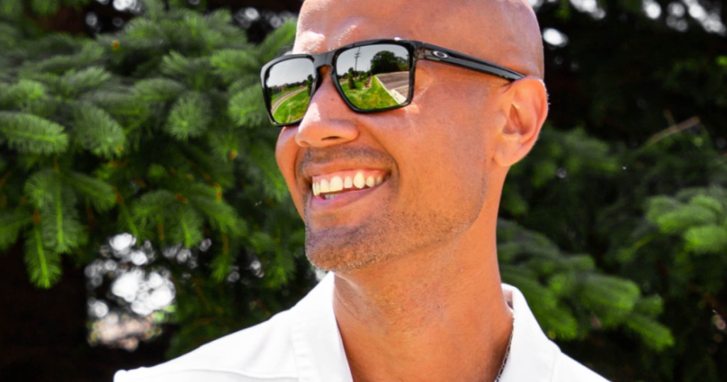 man smiling outside wearing black sunglasses