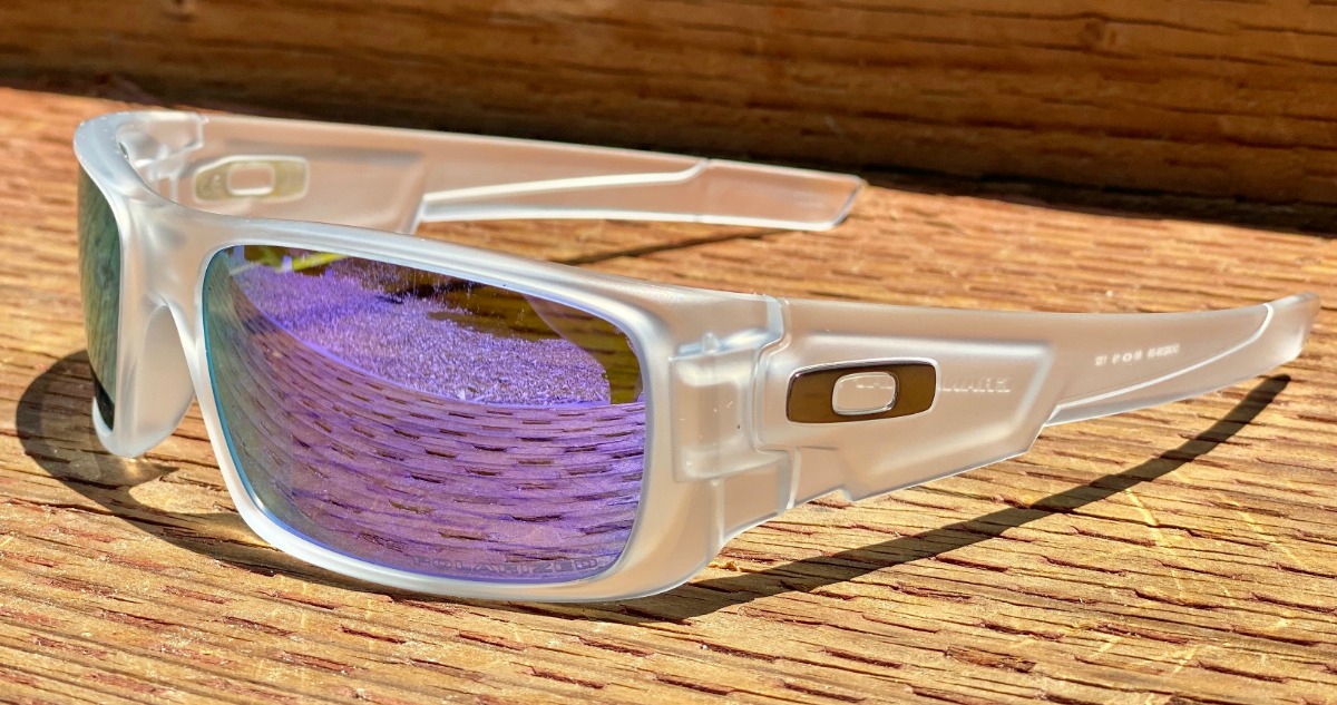 Oakley brand sunglasses on a wooden surface