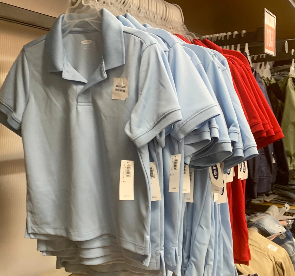 light blue and red polo shirts hanging on store display rack