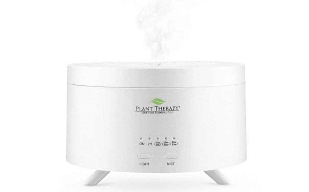 small short and round oil diffuser with steam coming from top