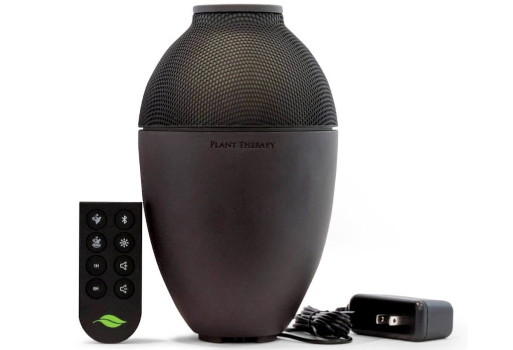 large black oil diffusers with power cord and remote next to it