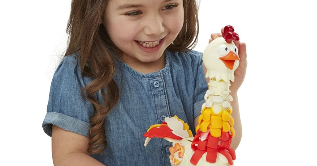 girl playing with Play-Doh chicken set