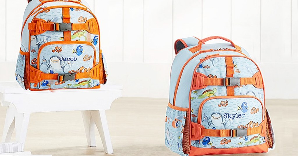 blue and orange finidng nemo print backpacks sitting on floor and white stool