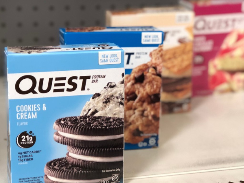 four boxes of various flavored protein bars on store shelf