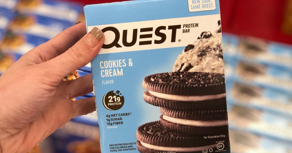 hand holding box of cookies n cream protein bars in store