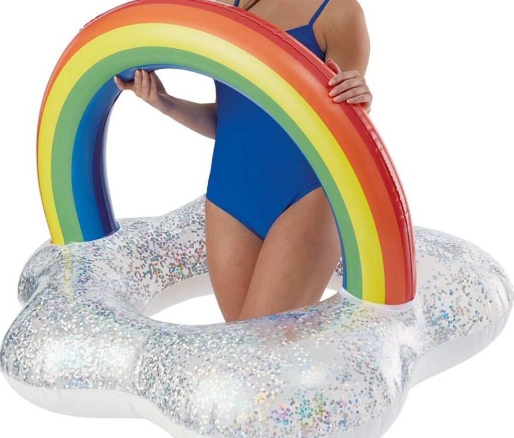 woman holding rainbow pool float