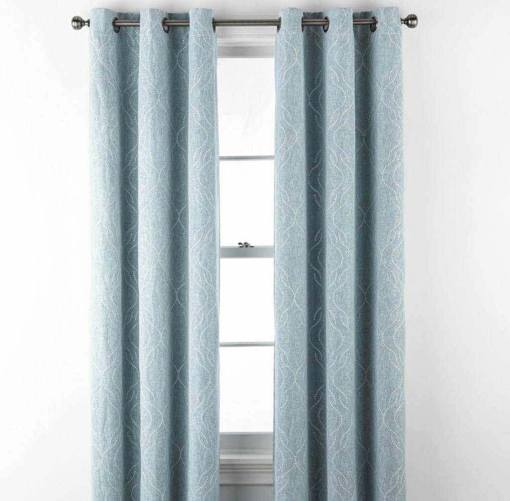blue curtain panels with white dotted print on white window