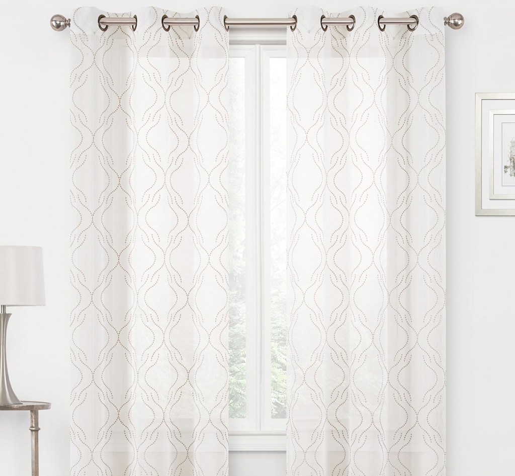 white curtain panels with tan print on white window