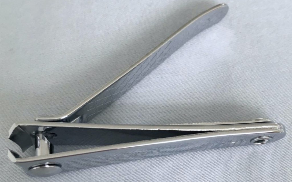 nail clippers laying on its side with handle up
