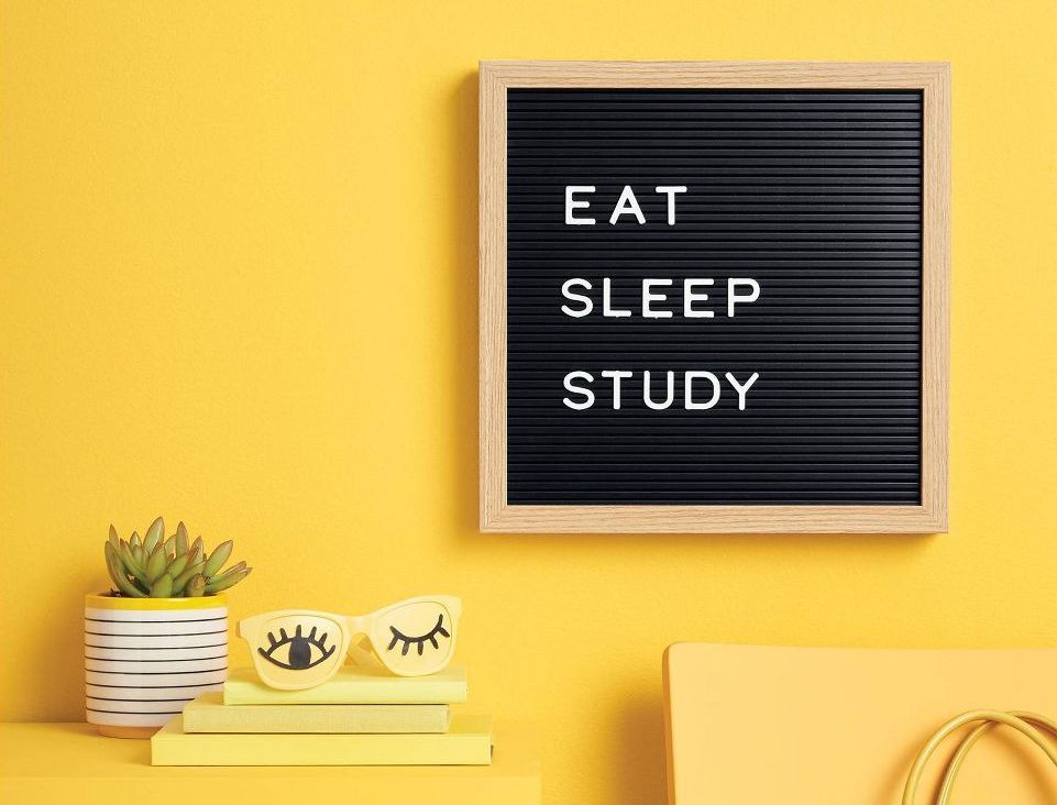 yellow wall with a letterboard hanging