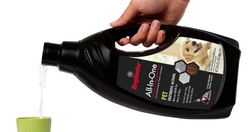 hand holding bottle of floor cleaning solution