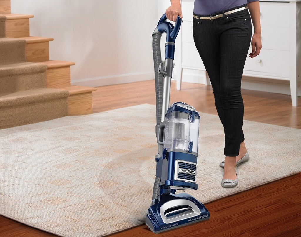 woman vacuuming a rug