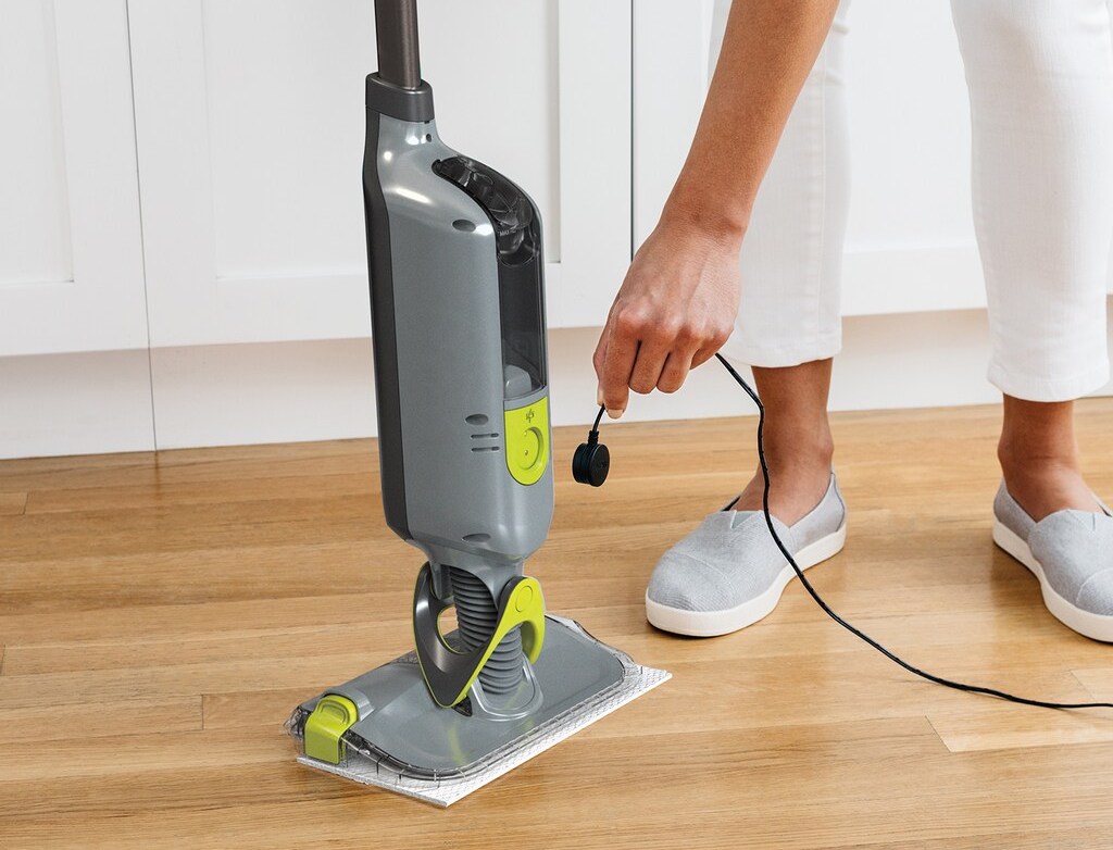person charging a vacuum