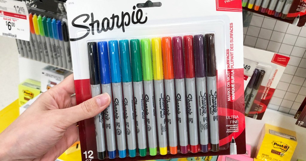 person holding 12-pack of ultra fine point sharpie markers in assorted colors