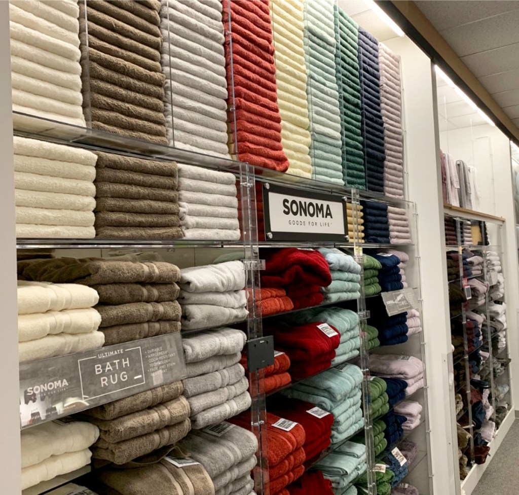 wall of folded bath towels in various colors with sonoma brand sign in front
