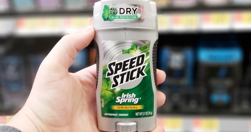 person holding a grey and green stick of speed stick irish spring deodorant