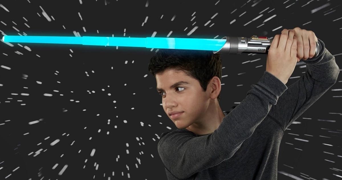 boy using toy lightsaber