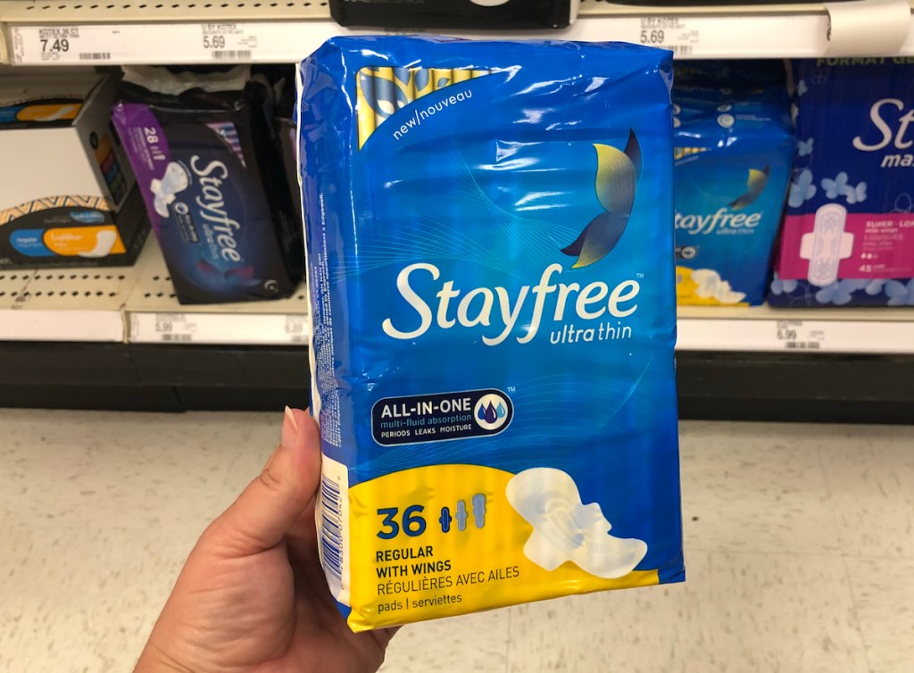 hand holding package of Stayfree pads