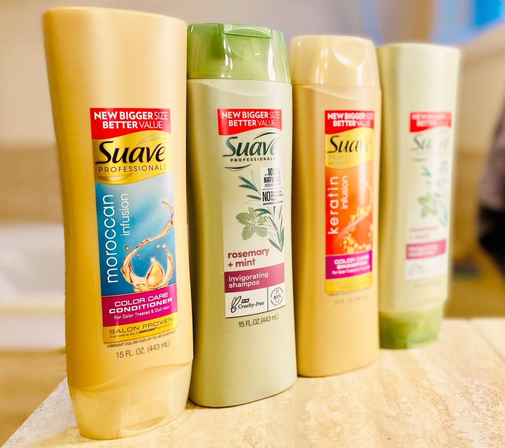 gold and green colored bottles of suave professionals shampoo and conditioner lined up on edge of tub