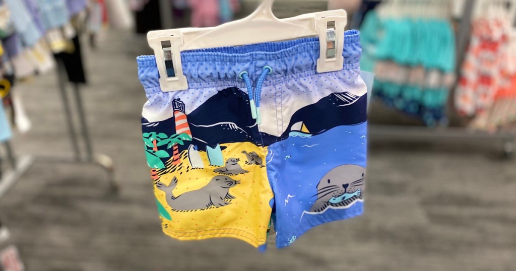 boys seal beach scene swim trunks on hanger in store