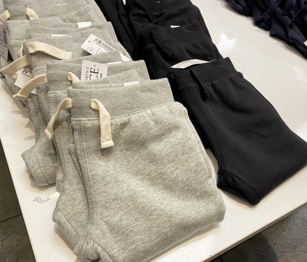 grey and black toddler boys shorts on store display table