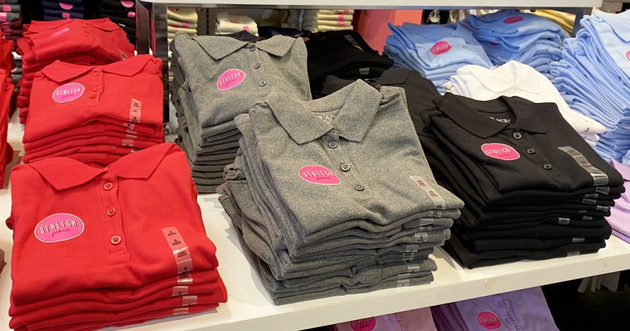 folded kids uniform polos in red, grey, and black colors