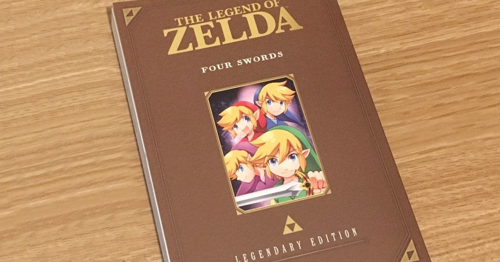 cover to the book legend of zelda four swords book on wood table