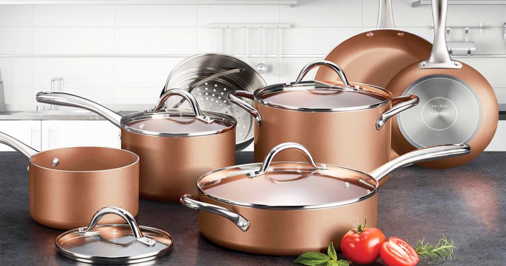 11-piece copper colored cookware set with pots, pans, matching lids, and steamer basket