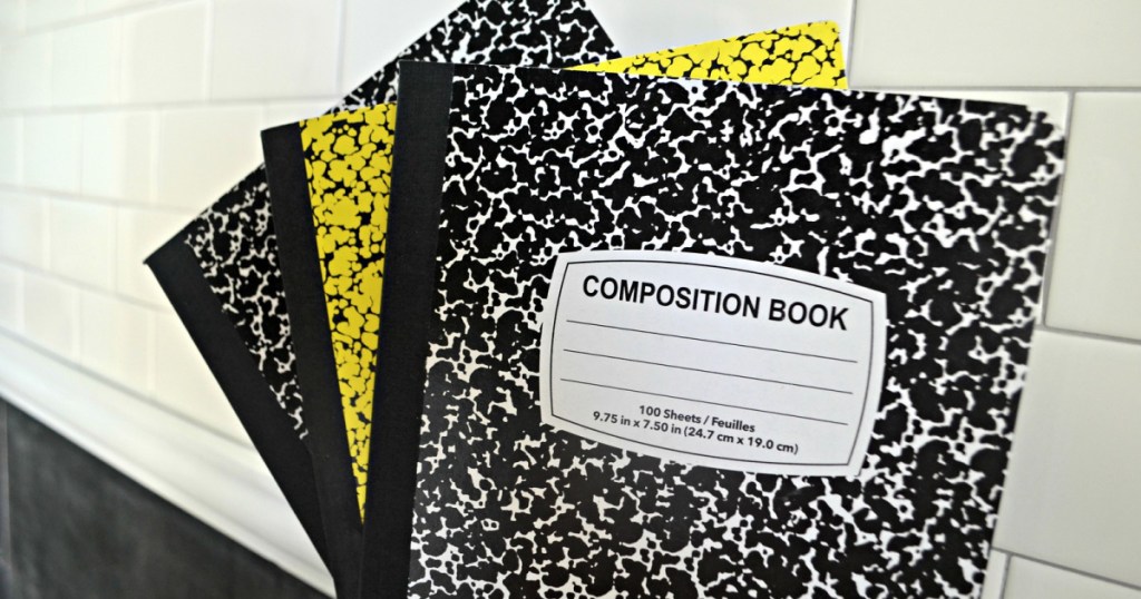 composition books in hand