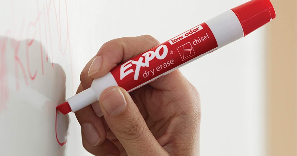 red expo marker in hand on whiteboard