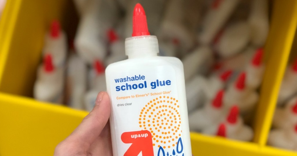 hand holding bottle of Up & Up school glue