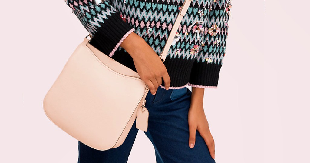 Woman holding a Kate Spade Margaux large crossbody