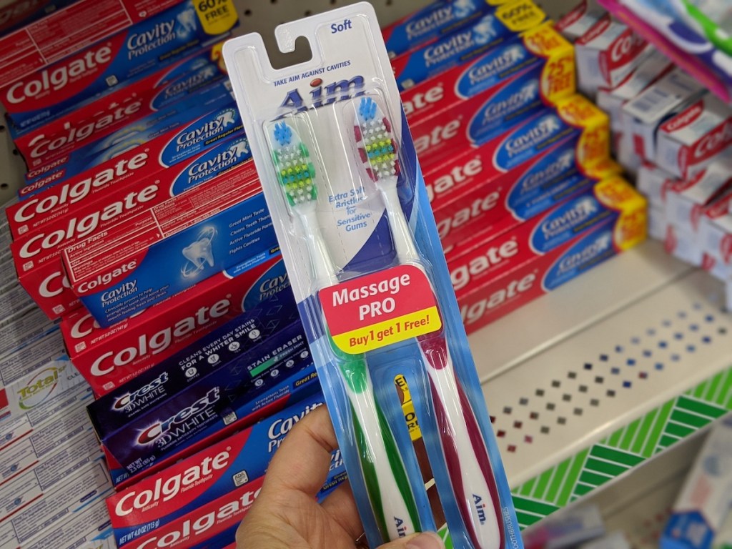 hand holding aim toothbrush 2 pack