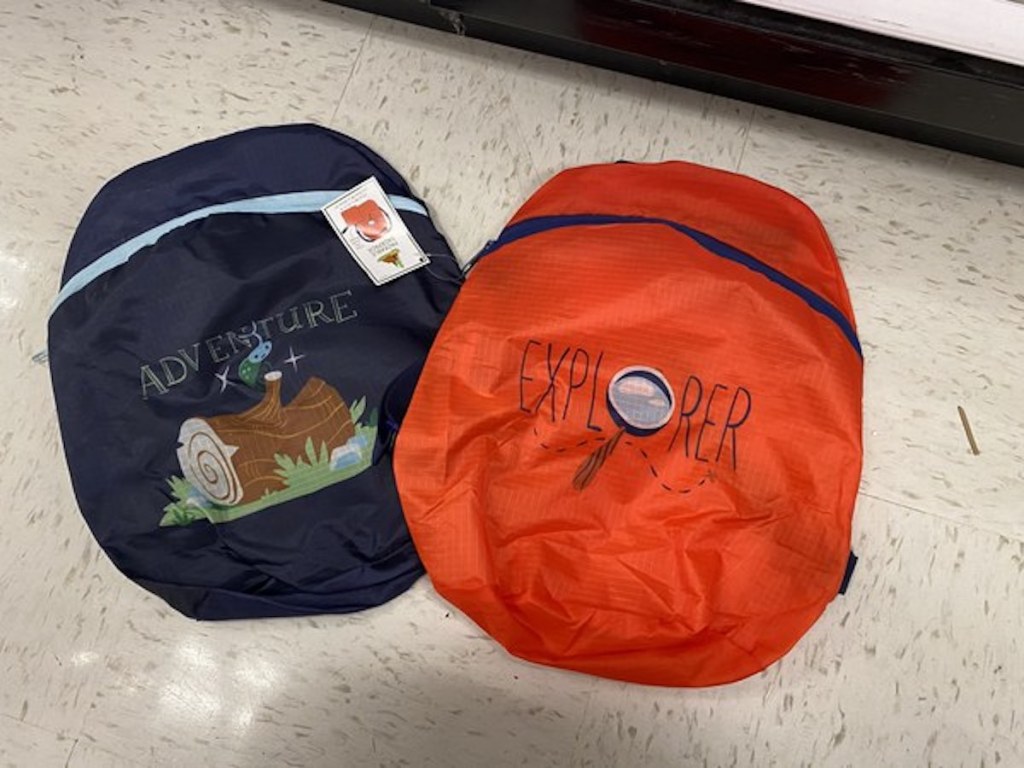 dark blue adventure backpack and red explorer backpack from the Target Bullseye