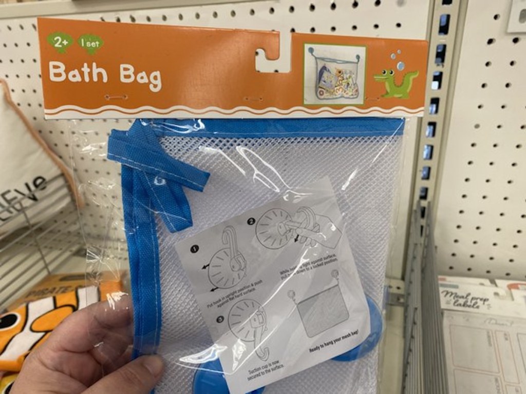 hand holding blue trimmed bath bag from the Target Bullseye