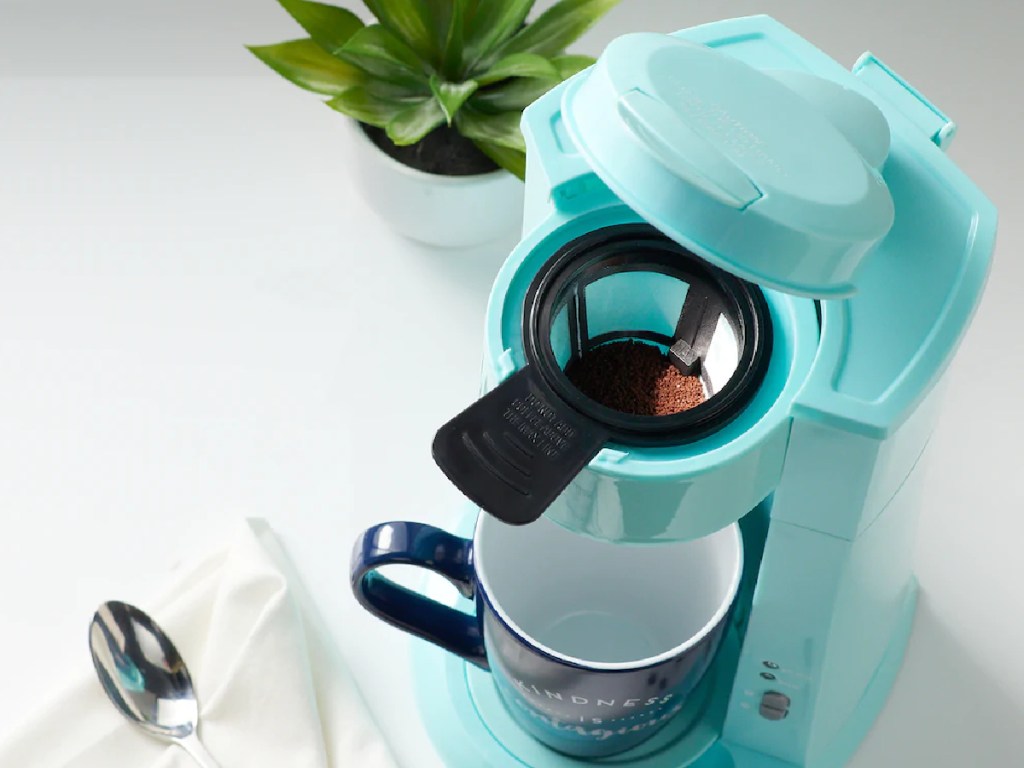 blue coffee maker on counter with top open