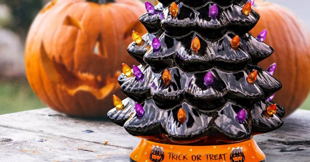 black ceramic halloween tree with jack o lantern pumpkins in the background