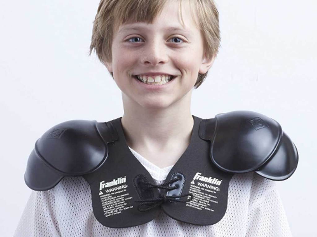 boy wearing shoulder pads
