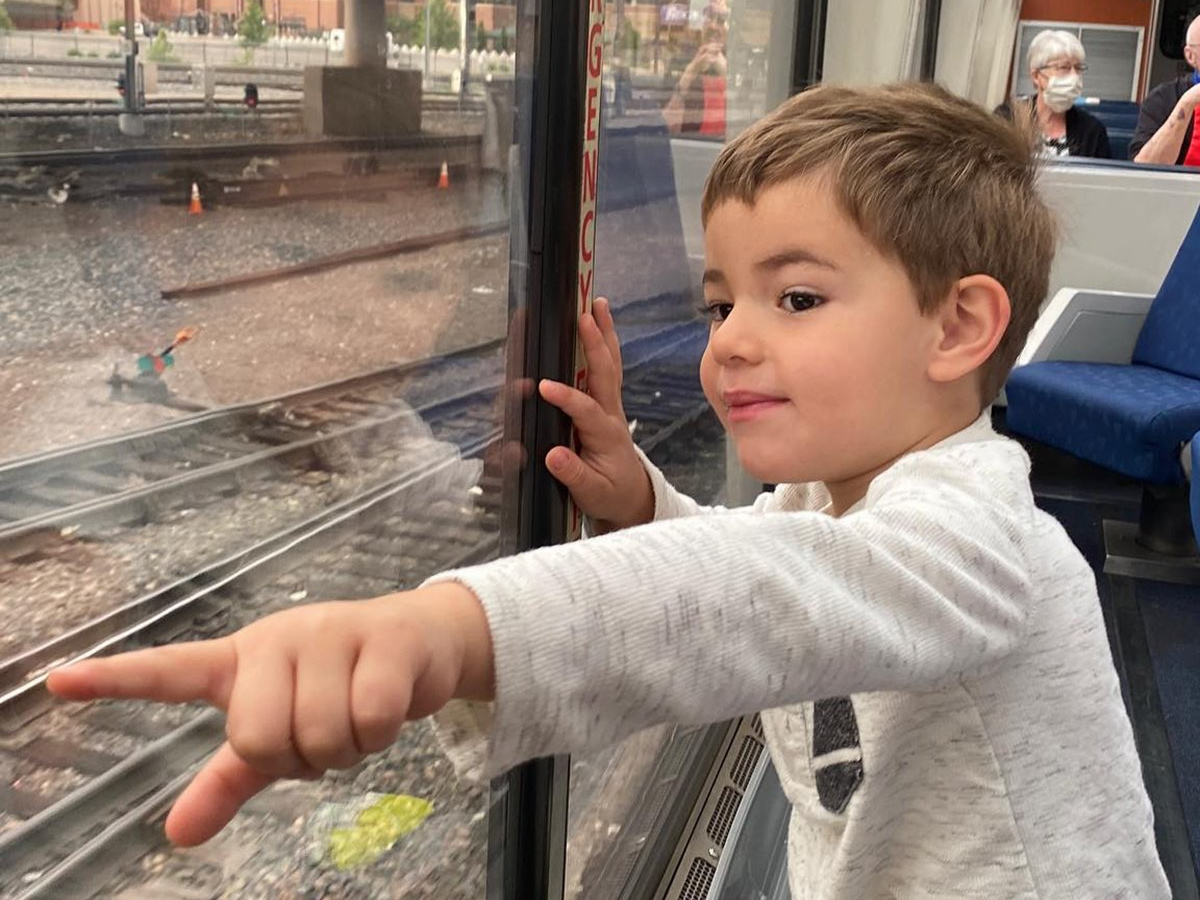 child pointing from train
