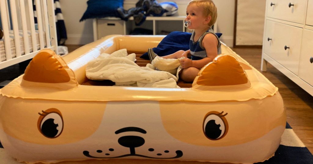 child sitting in a Sable Portable Kids Air Mattress with Electric Air Pump