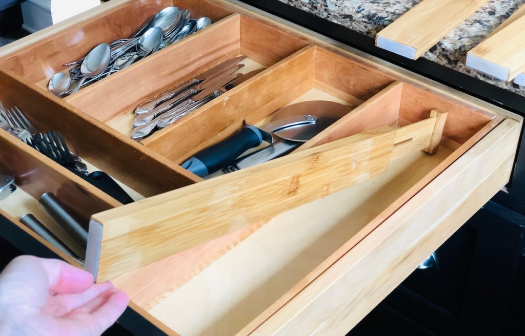 hand holding a bamboo drawer divider