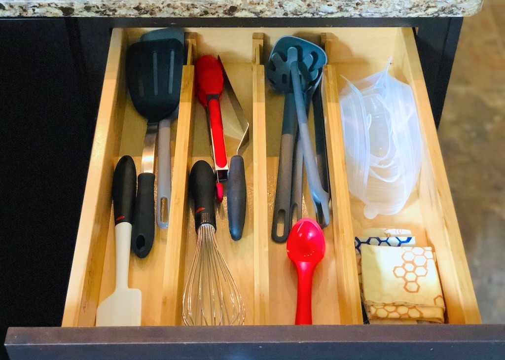 kitchen drawer with dividers and various types of cooking utensils 
