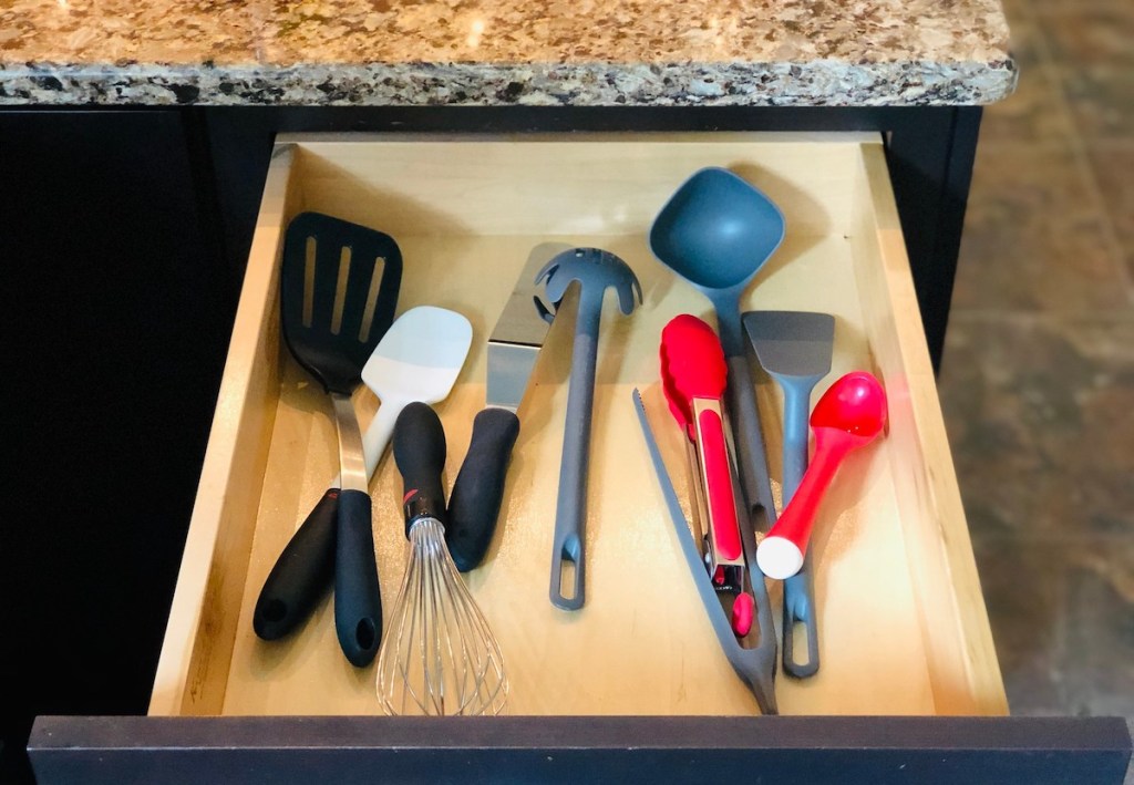 drawer open with various types of cooking utensils