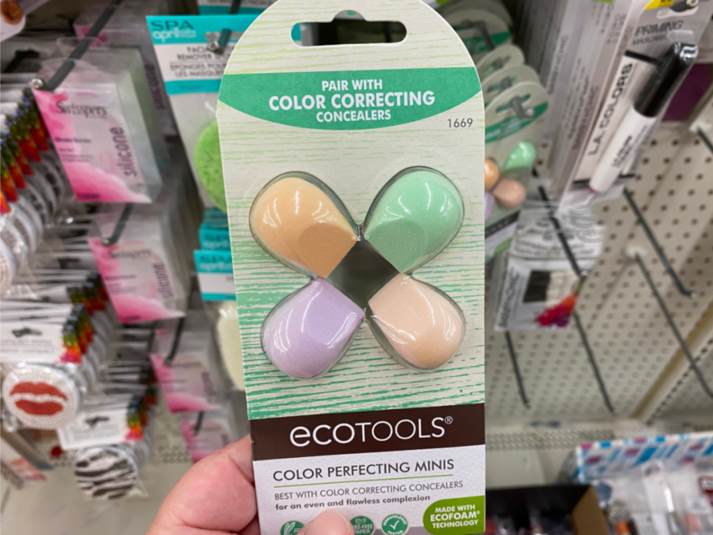 hand holding package of beauty blenders by store display