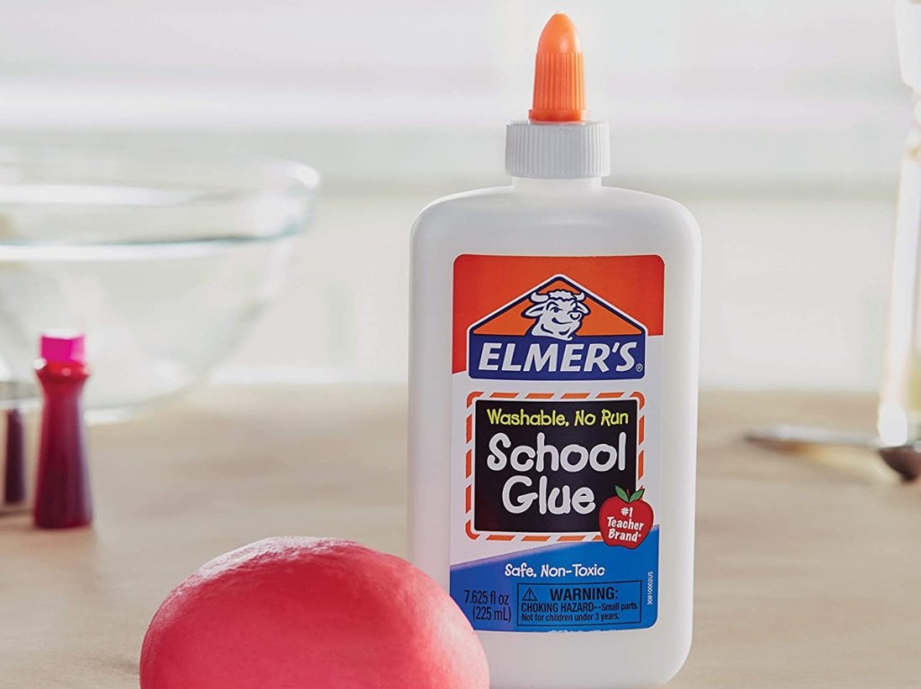 bottle of glue next to red slime