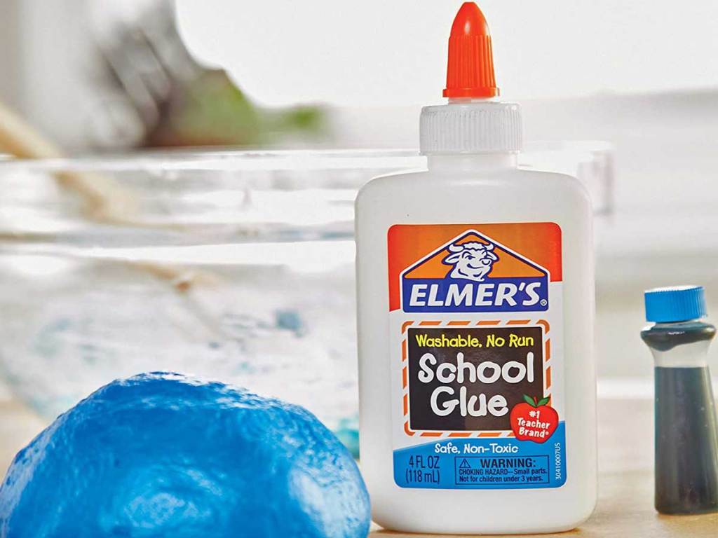 bottle of liquid glue next to a ball of slime